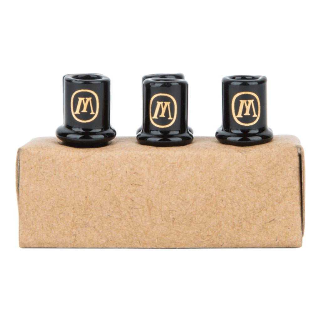 a couple of black knobs sitting on top of a cardboard box